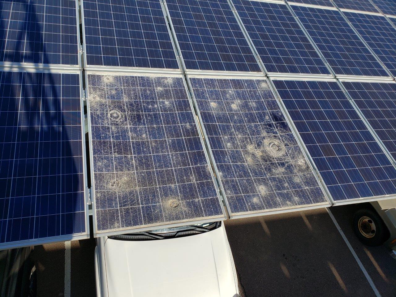 Several modules were damaged by hail on one of many carport arrays on the base.