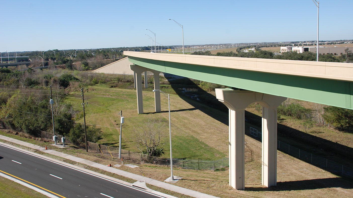 One of the four bridges was designed with steel materials due to span lengths that exceeded standard concrete U-beam bridge capacity.