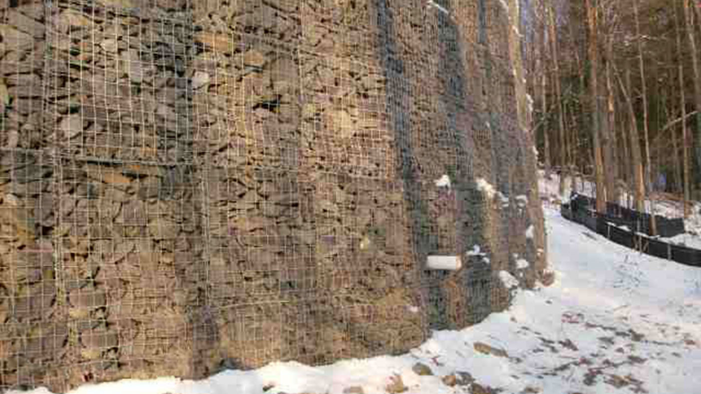 We installed a large gabion retaining wall and guard rail along the access road and around the compound to minimize the impact to the surrounding wetlands.