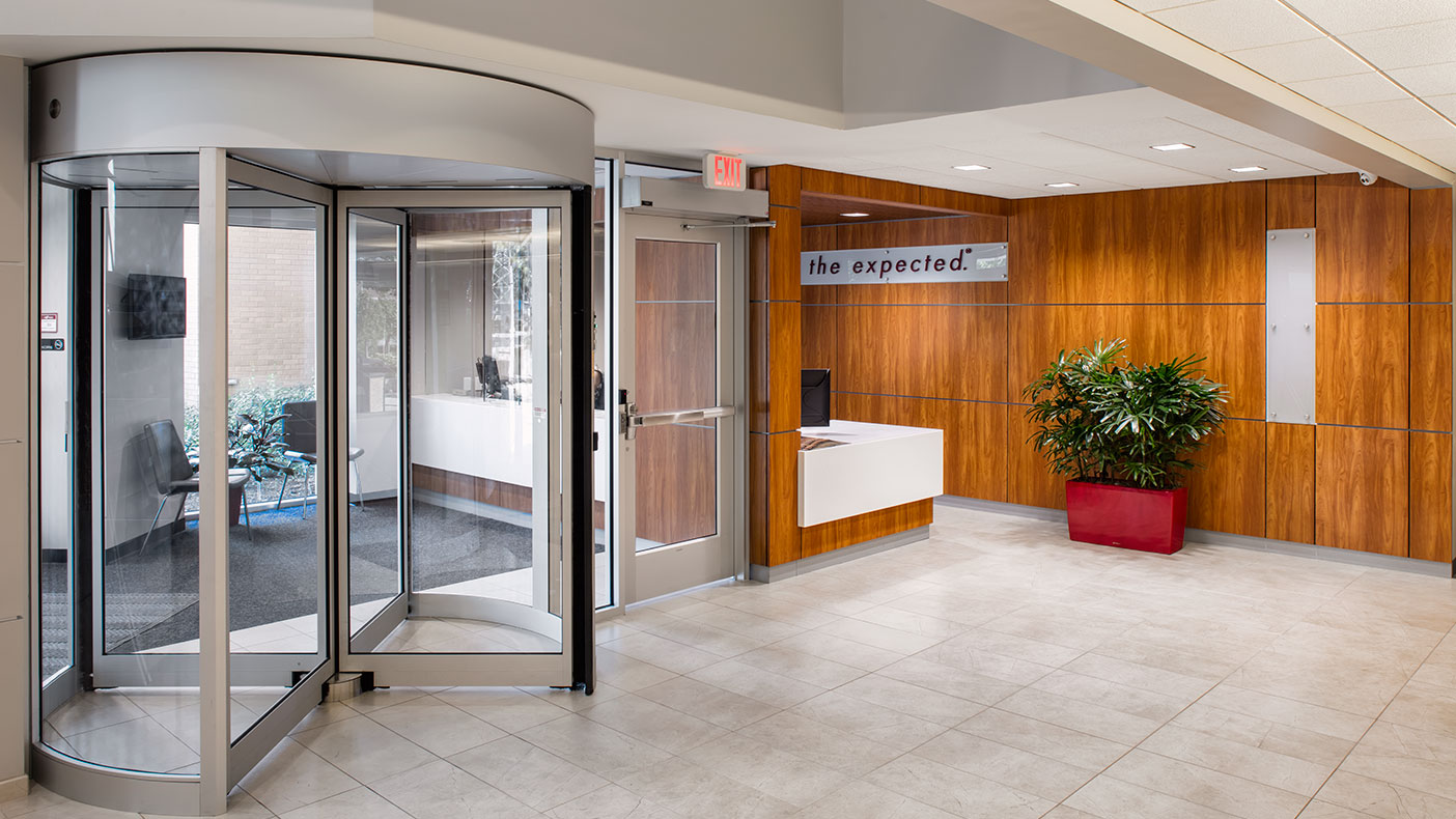 The updated main entrance features a revolving door, openings that allow daylighting, and an improved flow of public interaction.