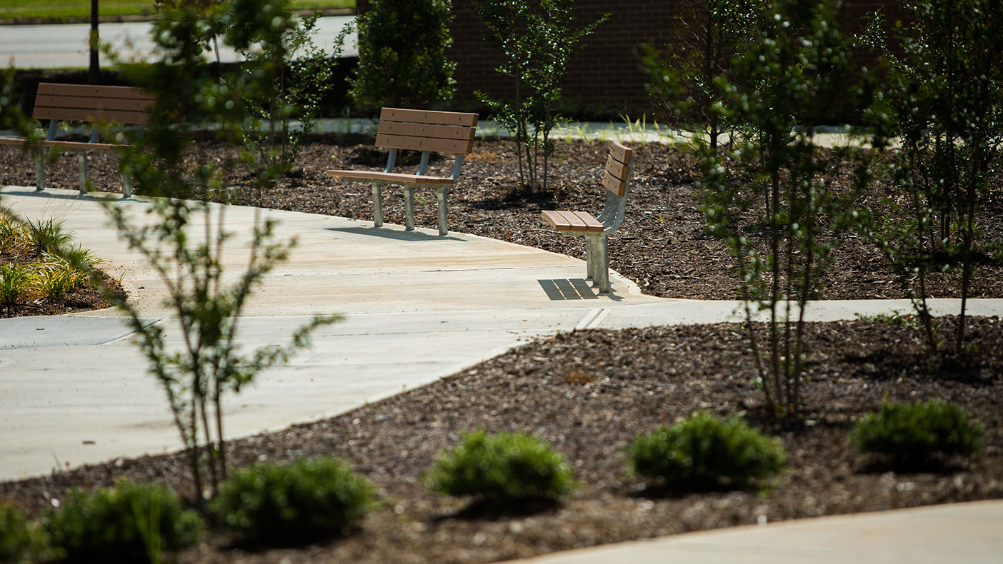 Our design features benches, which are strategically located throughout the gardens, as well as landscaping that draws attention to important aspects of the landscape, including the statue, fountain, and pavilion.