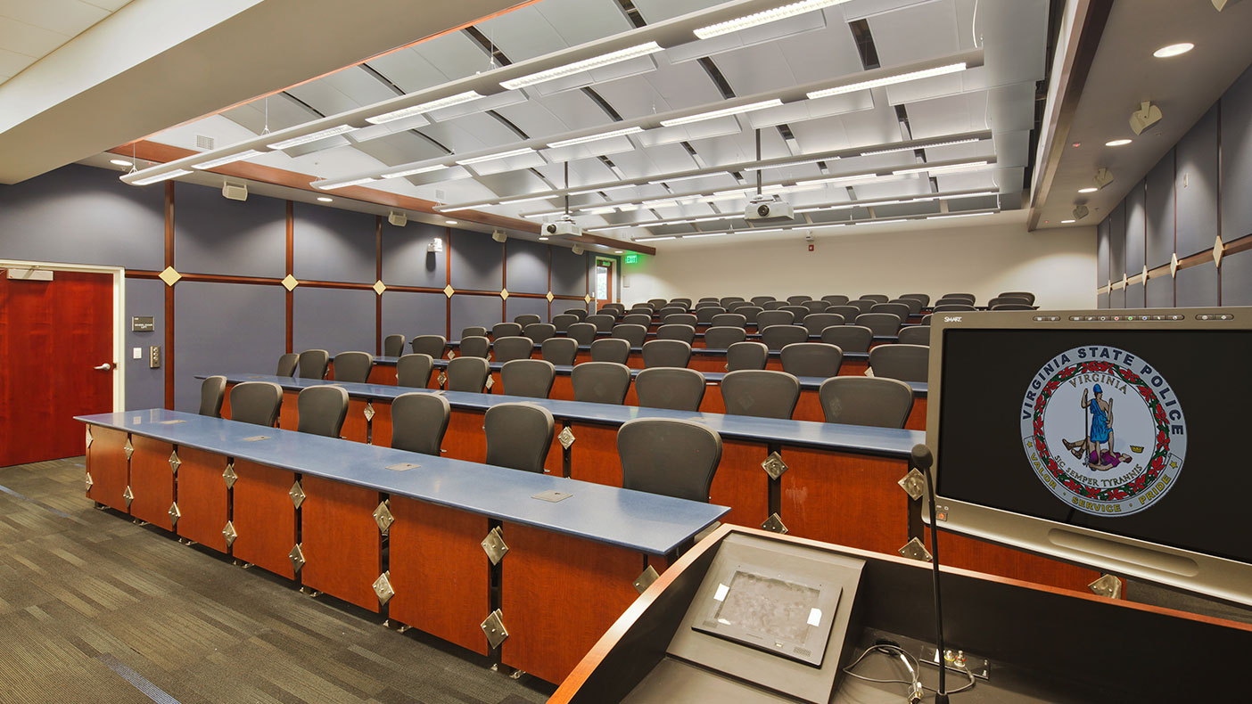 The training building includes 60 squad rooms that accommodate up to 120 cadets, theater-style classrooms, a cafeteria, offices, and meeting space.