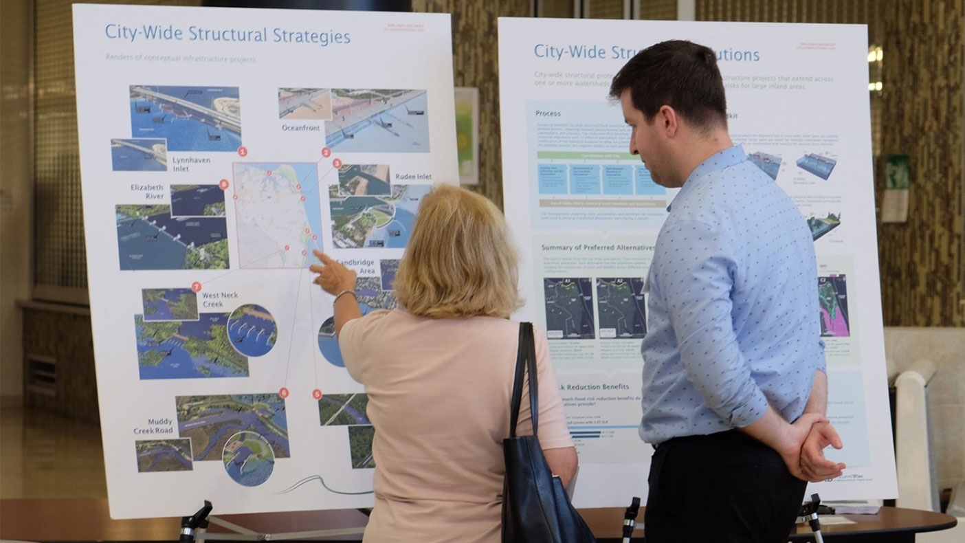 Connor Rutten discussing with a resident the structural flood defense options our team developed for locations across the city.
