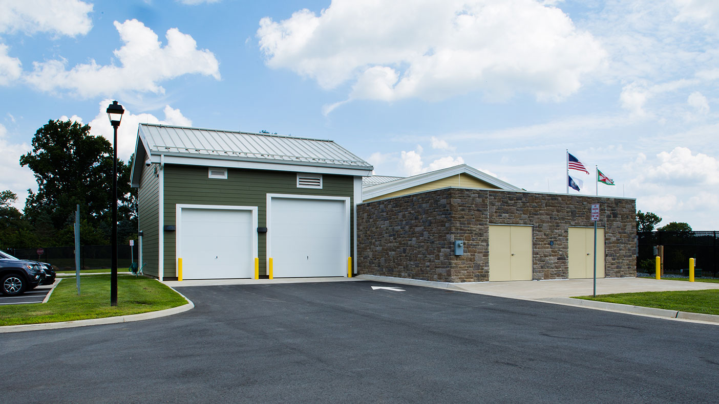 The design includes an external storage building adjacent to the station.