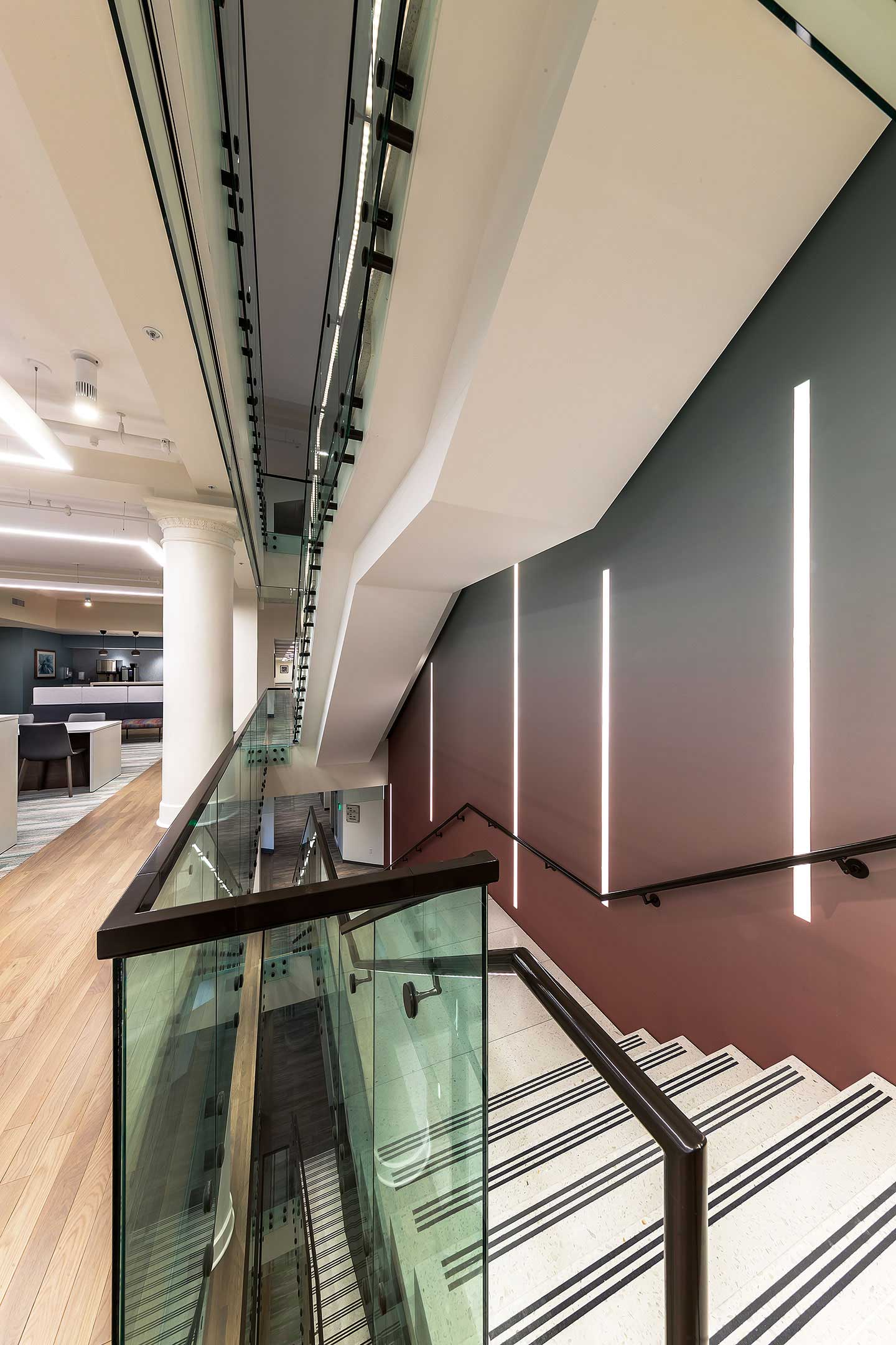 A defunct historic escalator was removed, providing space for a six-story activated stair through the central core that dynamically connects work groups, supports engaging collaboration spaces, and encourages fitness.